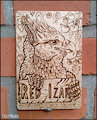 Wooden badge for Red Izak (pyrography) by FuzzyMaro