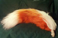 Orange and white Husky yarn tail